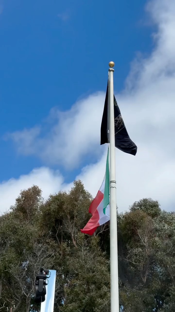 Flags moving against a bright blue sky